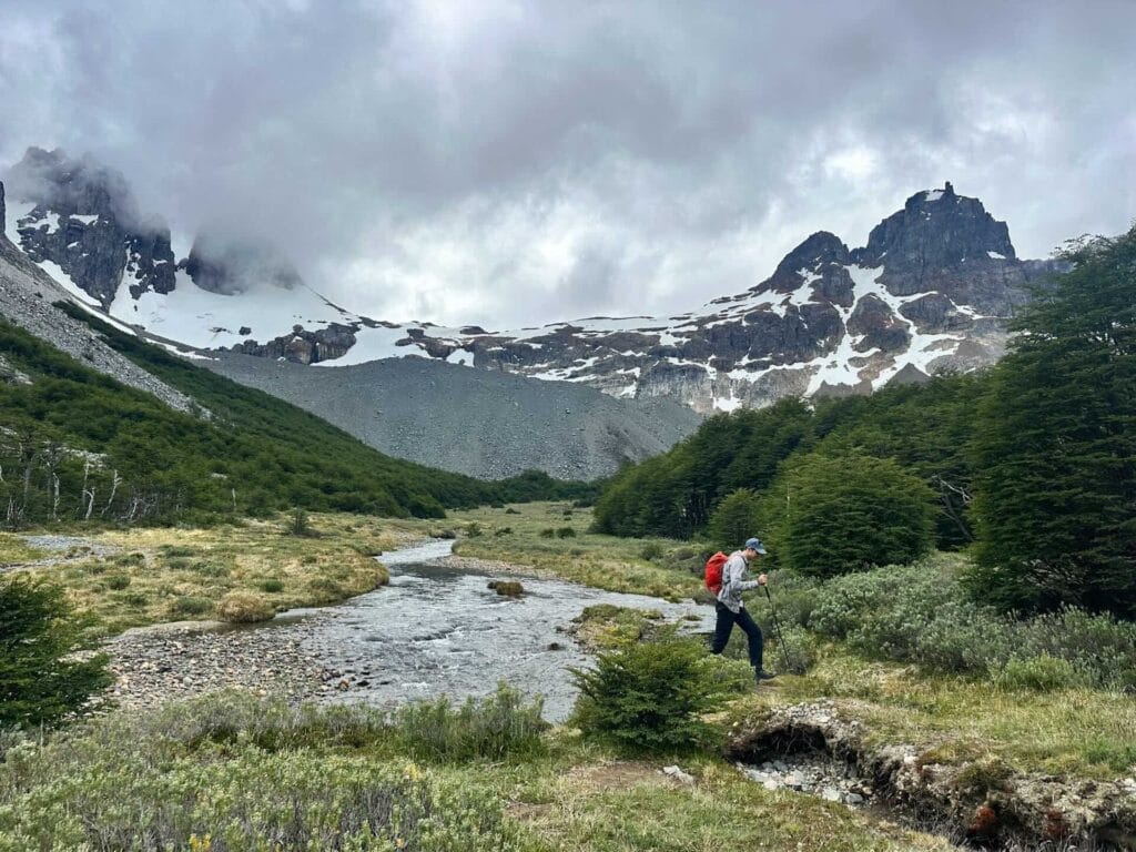 Las Horquetas Trek, Cerro Castillo National Park, Patagonia, hiker, trekking, river, snow-capped mountains, cloudy sky, forest