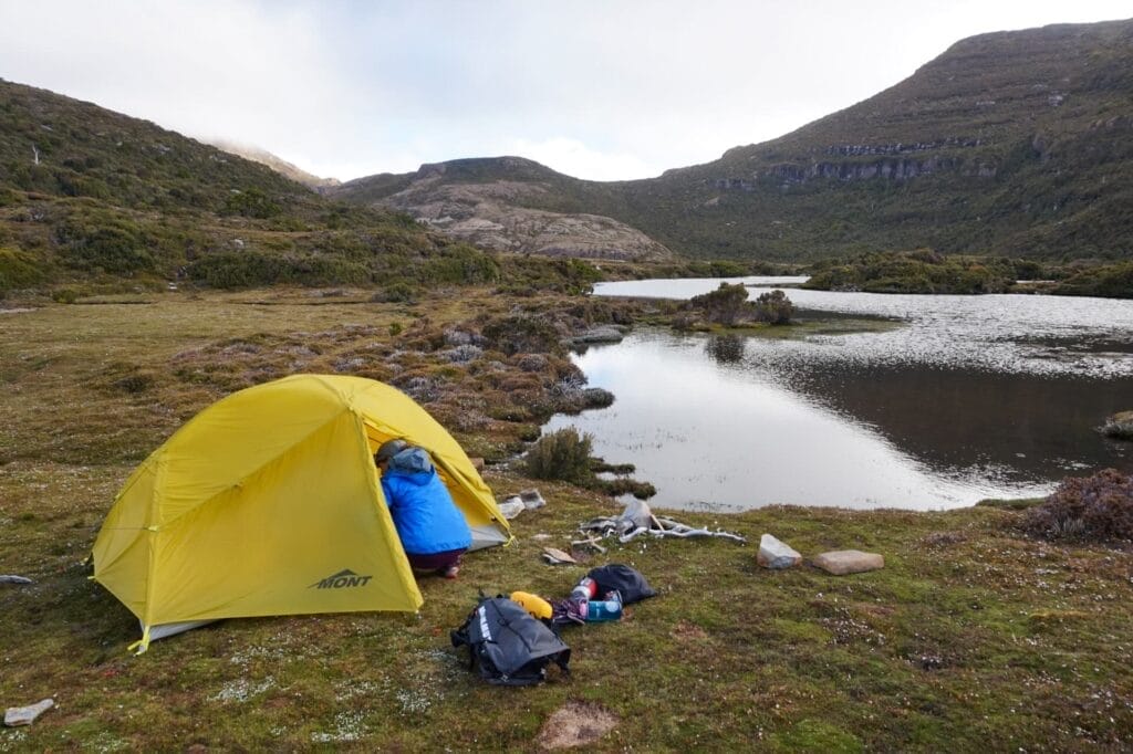 Tasmanian wilderness, by Mat, solo camping, yellow tent, tranquil lake, multi-day hike