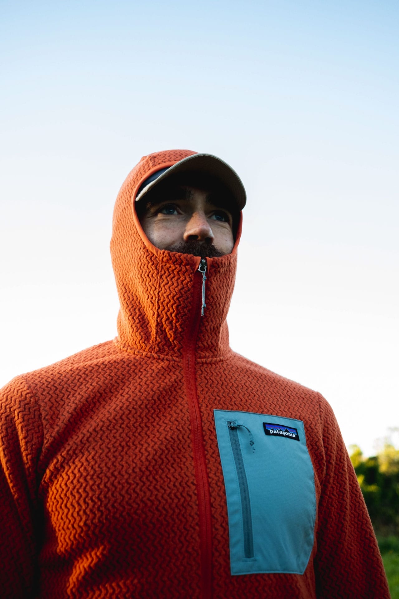 Why Every Explorer Needs a Technical Fleece Like This One, photo by Ella Garbett, model Lachie Hand, R1 Air fleece, orange, stormhood