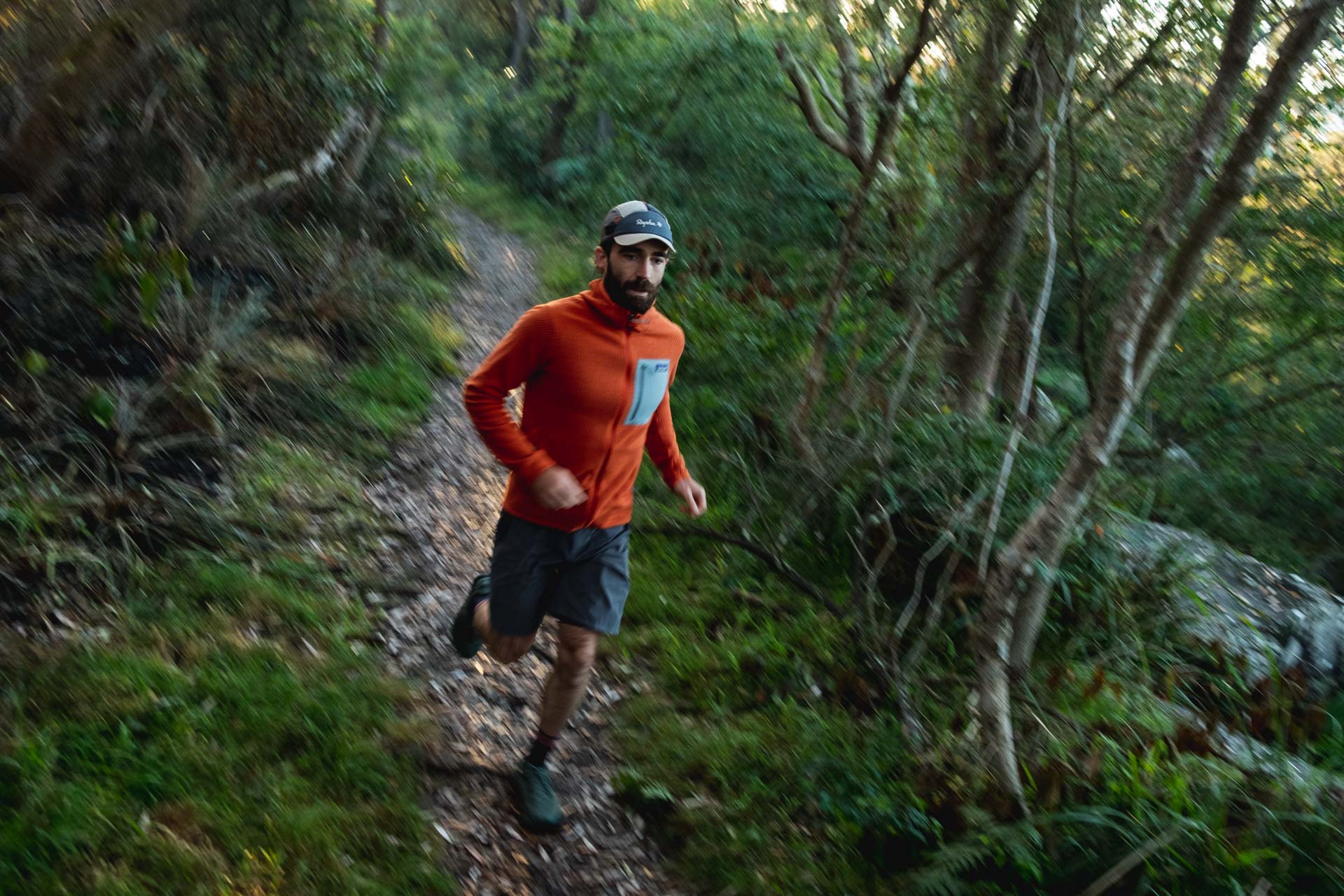 Why Every Explorer Needs a Technical Fleece Like This One, photo by Ella Garbett, model Lachie Hand, R1 Air fleece, orange, running