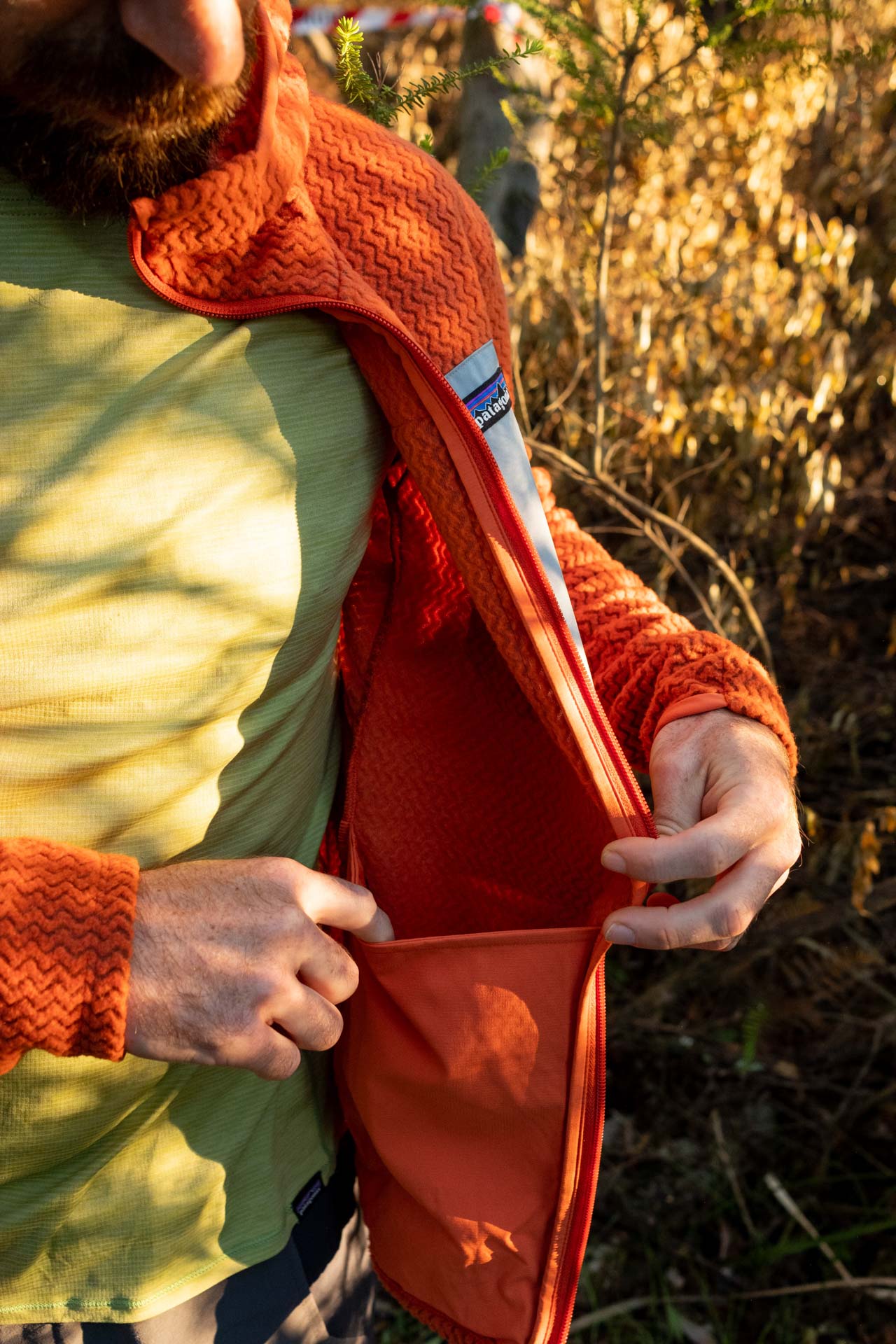 Why Every Explorer Needs a Technical Fleece Like This One, photo by Ella Garbett, model Lachie Hand, R1 Air fleece, orange, dump pocket